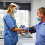 Medical officeA nurse checking blood pressure off a senior man.