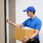 Delivery man hand ringing doorbell.